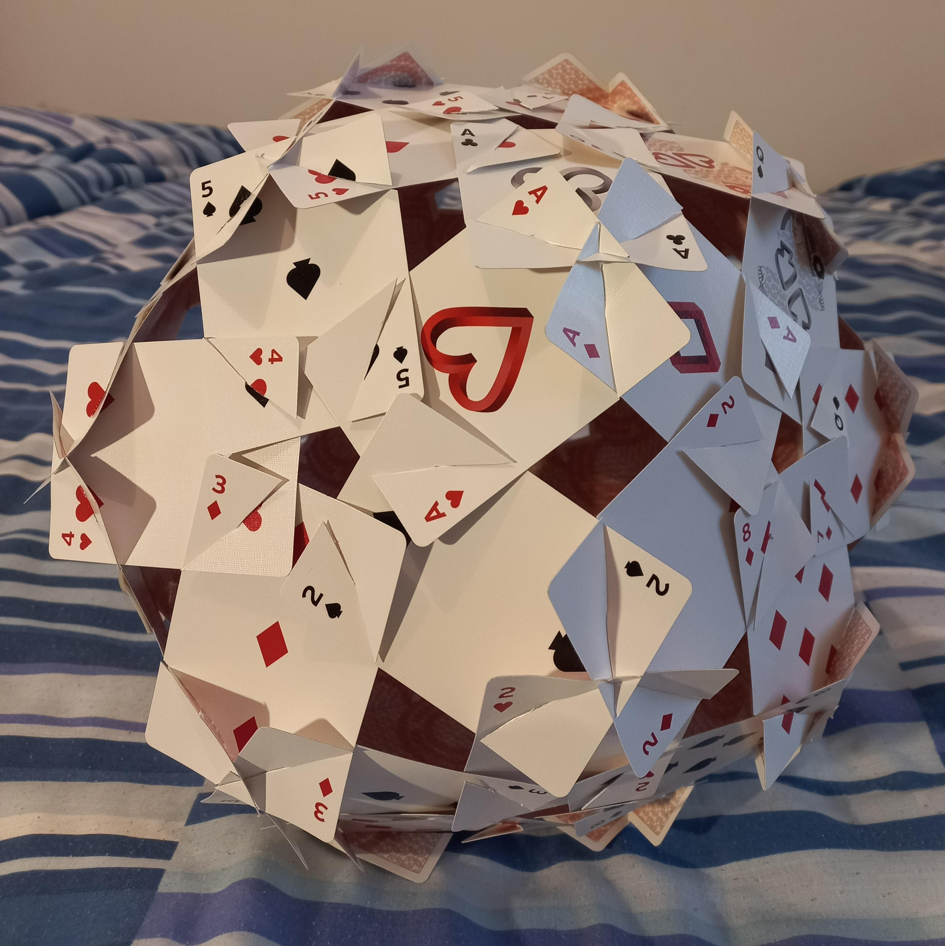 A deltoidal hexecontahedron made out of playing cards.