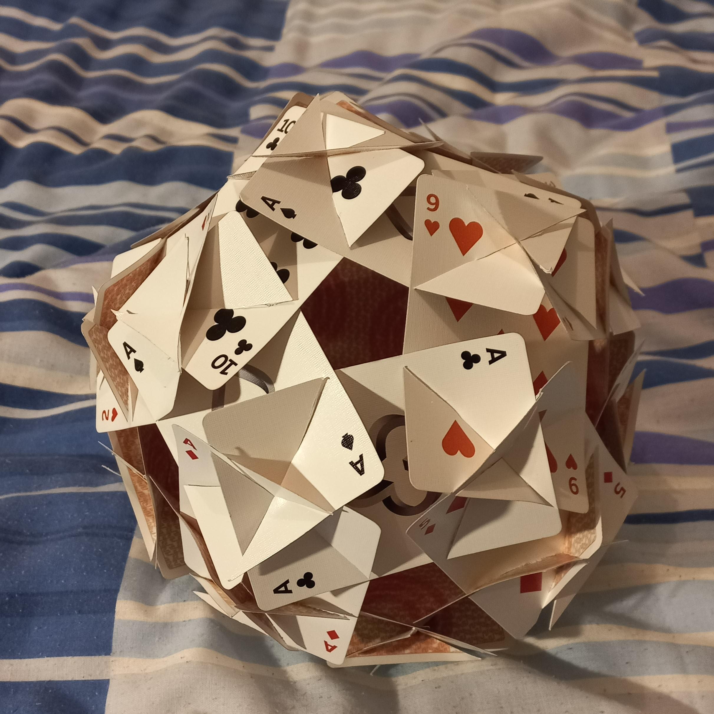 A rhombic triacontahedron made out of playing cards.